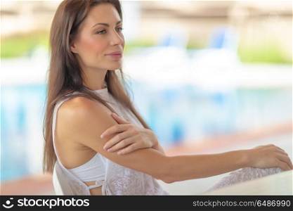 Portrait of a beautiful gentle woman on beach resort, authentic genuine beauty of young female, peaceful summer vacation. Gentle woman on beach resort