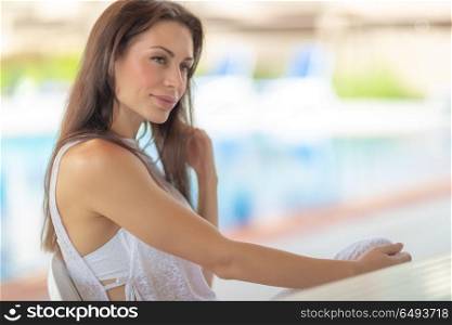 Portrait of a beautiful gentle woman on beach resort, authentic genuine beauty of young female, peaceful summer vacation. Gentle woman on resort