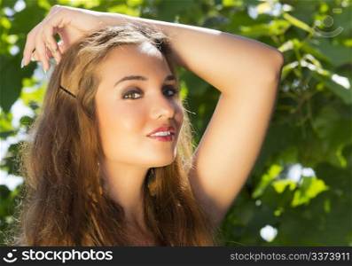 Portrait of a beautiful girl against floral background