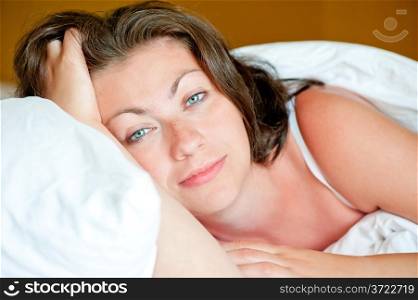 Portrait of a beautiful girl has woken up in bed in the morning