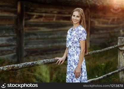 Portrait of a beautiful girl in a blue dress in the field at sunset. Portrait of a beautiful girl in a blue dress in the field at sunset. Summer. unity with nature.