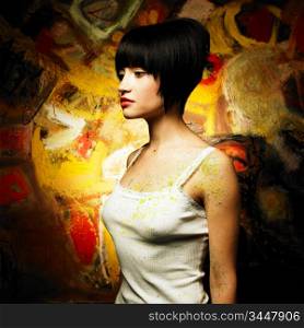 Portrait of a beautiful girl on a background of abstract painting