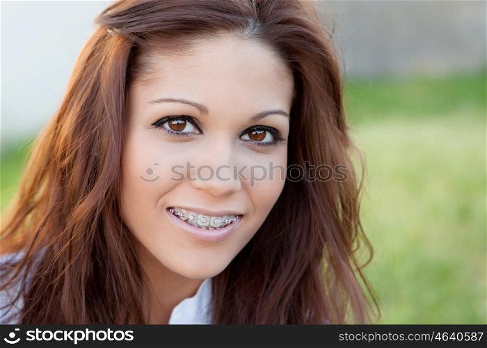 Portrait of a beautiful girl with brackets at the park