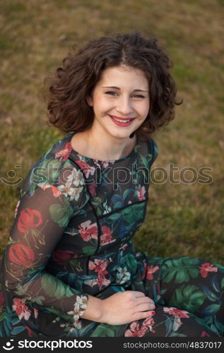 Portrait of a beautiful girl with curly hair in the landscape