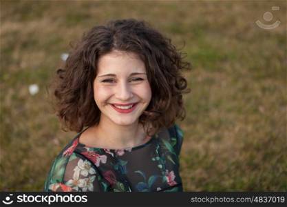 Portrait of a beautiful girl with curly hair in the landscape