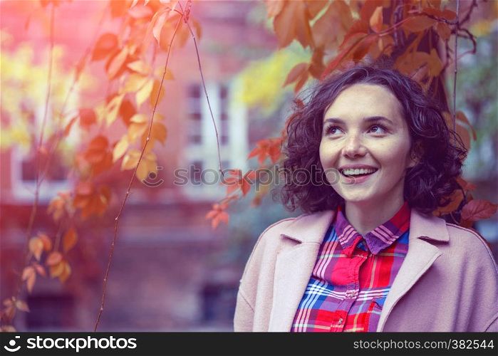 portrait of a beautiful happy smiling girl at the outdoor. Autumn