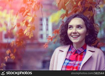 portrait of a beautiful happy smiling girl at the outdoor. Autumn