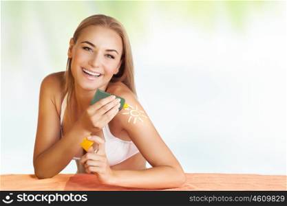 Portrait of a beautiful happy woman applying sunblock, tanning on the beach, young adult girl enjoying summer holidays, healthy lifestyle and skin protection concept
