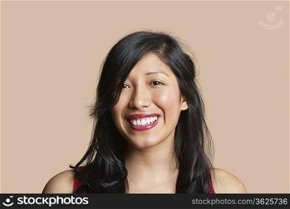 Portrait of a beautiful happy woman over colored background