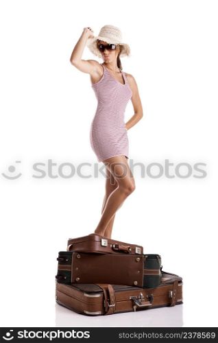 Portrait of a beautiful happy young woman standing over the baggage