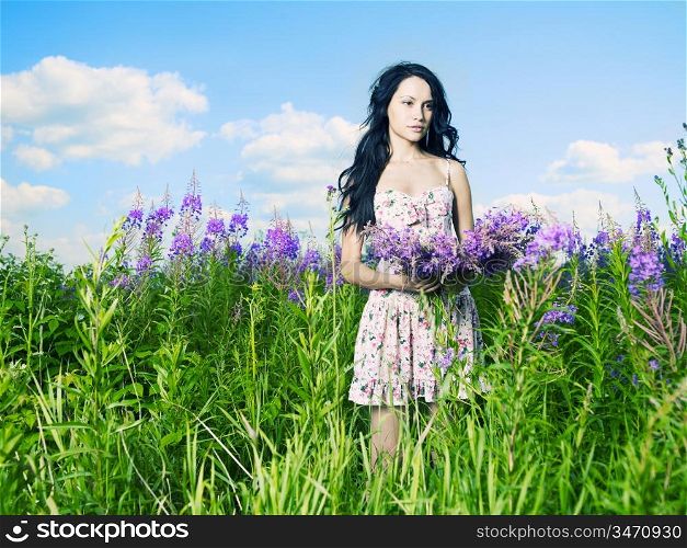 Portrait of a beautiful lady in a flower meadow