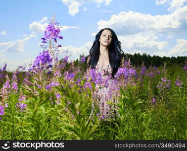 Portrait of a beautiful lady in a flower meadow