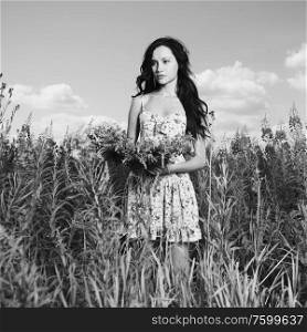 Portrait of a beautiful lady in a flower meadow