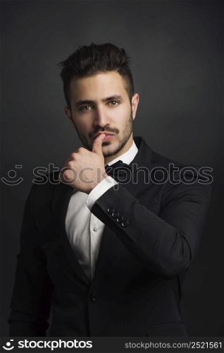 Portrait of a beautiful latin man smiling wearing a tuxedo