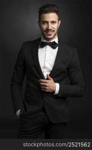 Portrait of a beautiful latin man smiling wearing a tuxedo
