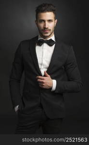 Portrait of a beautiful latin man smiling wearing a tuxedo