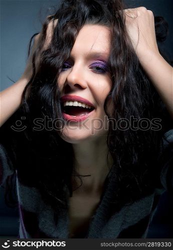 Portrait of a beautiful laughing brunette hair model. Hairstyle. Beauty. Lifestyle