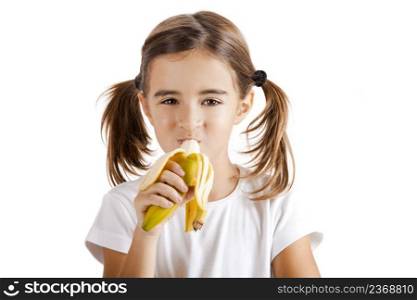 Portrait of a beautiful little girl eating a banana
