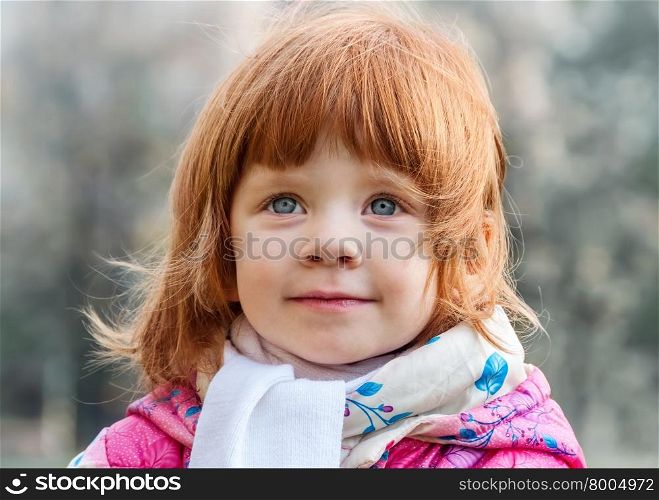 Portrait of a beautiful little girl in the park