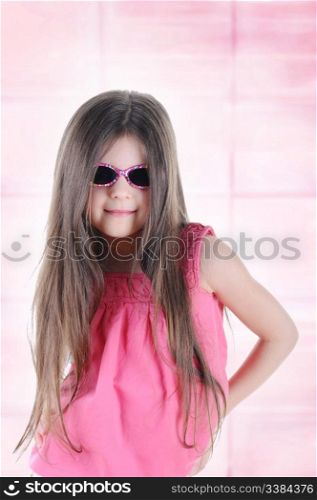 Portrait of a beautiful little long-haired brunette in sunglasses.