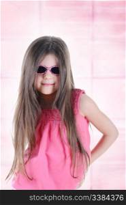 Portrait of a beautiful little long-haired brunette in sunglasses.