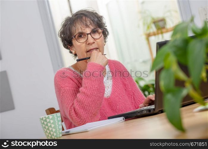 portrait of a beautiful mature woman dressed with a pink sweater