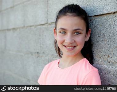 Portrait of a beautiful preteen girl with blue eyes outside