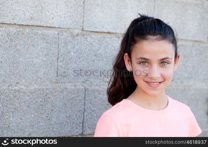 Portrait of a beautiful preteen girl with blue eyes outside