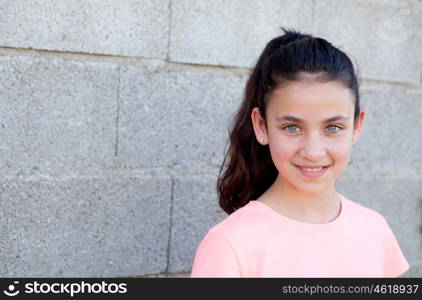 Portrait of a beautiful preteen girl with blue eyes outside