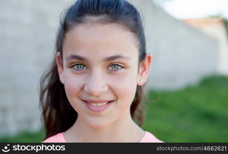 Portrait of a beautiful preteen girl with blue eyes outside