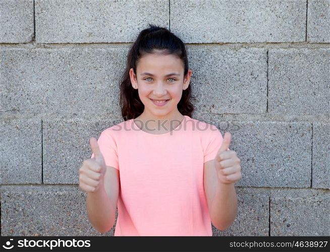 Portrait of a beautiful preteen girl with blue eyes saying Ok