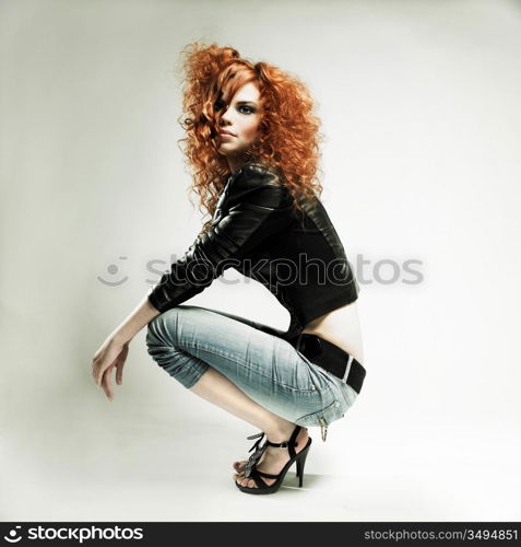 Portrait of a beautiful redheaded girl sitting