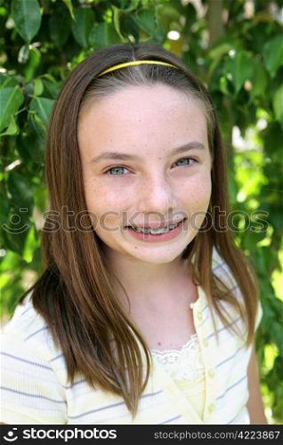 Portrait of a beautiful school girl with freckles and braces.