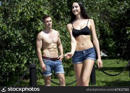 Portrait of a beautiful sexy young couple in blue jeans