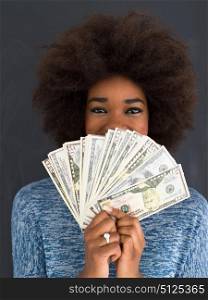 Portrait of a beautiful smiling afro american woman holding money isolated on a gray background