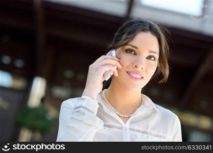 Portrait of a beautiful smiling businesswoman on the phone in a office building