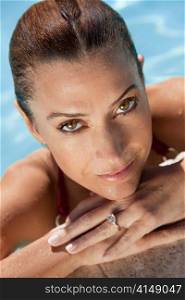 Portrait of a Beautiful Smiling Woman Relaxing In Swimming Pool