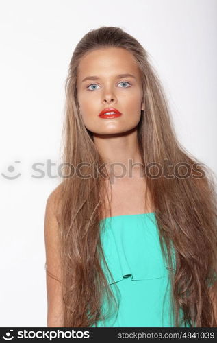 Portrait of a beautiful teenage girl with long hair in studio.