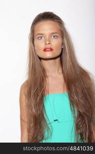 Portrait of a beautiful teenage girl with long hair in studio.