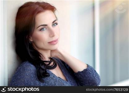 Portrait of a beautiful thoughtful woman outdoors, gorgeous model with natural makeup in bright sunlight, authentic beauty of a young female