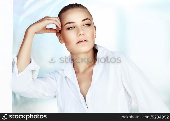 Portrait of a beautiful woman at home in the morning, gorgeous female wearing white mens shirt, perfect natural beauty