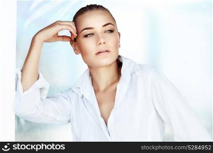 Portrait of a beautiful woman at home in the morning, gorgeous female wearing white mens shirt, perfect natural beauty
