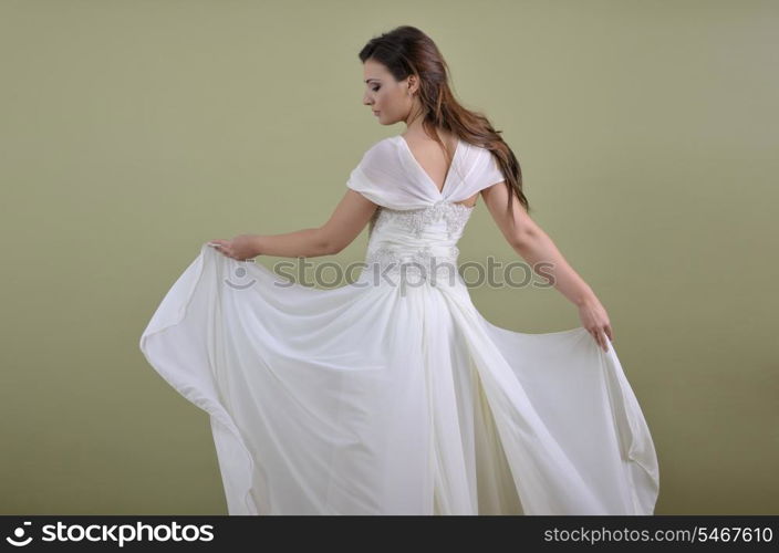 Portrait of a beautiful woman dressed as a bride isolated on white background in studio