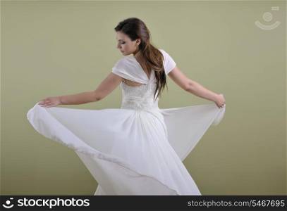 Portrait of a beautiful woman dressed as a bride isolated on white background in studio