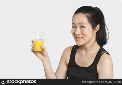 Portrait of a beautiful woman having a glass of orange juice