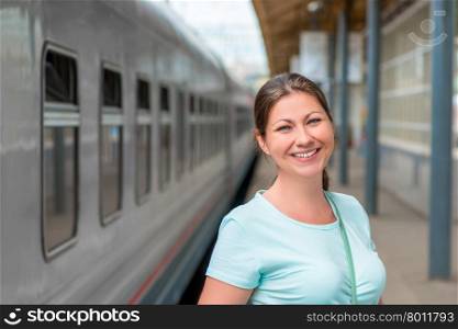 portrait of a beautiful woman in a train station near the train