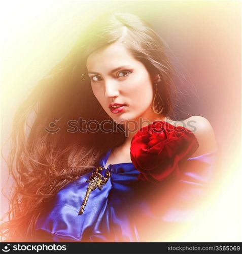 portrait of a beautiful woman in blue dress whith rose