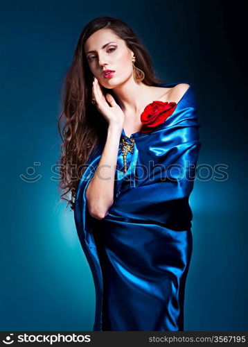 portrait of a beautiful woman in blue dress whith rose