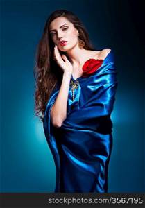portrait of a beautiful woman in blue dress whith rose