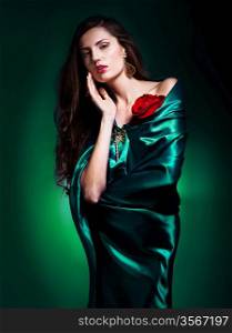 portrait of a beautiful woman in green dress whith rose